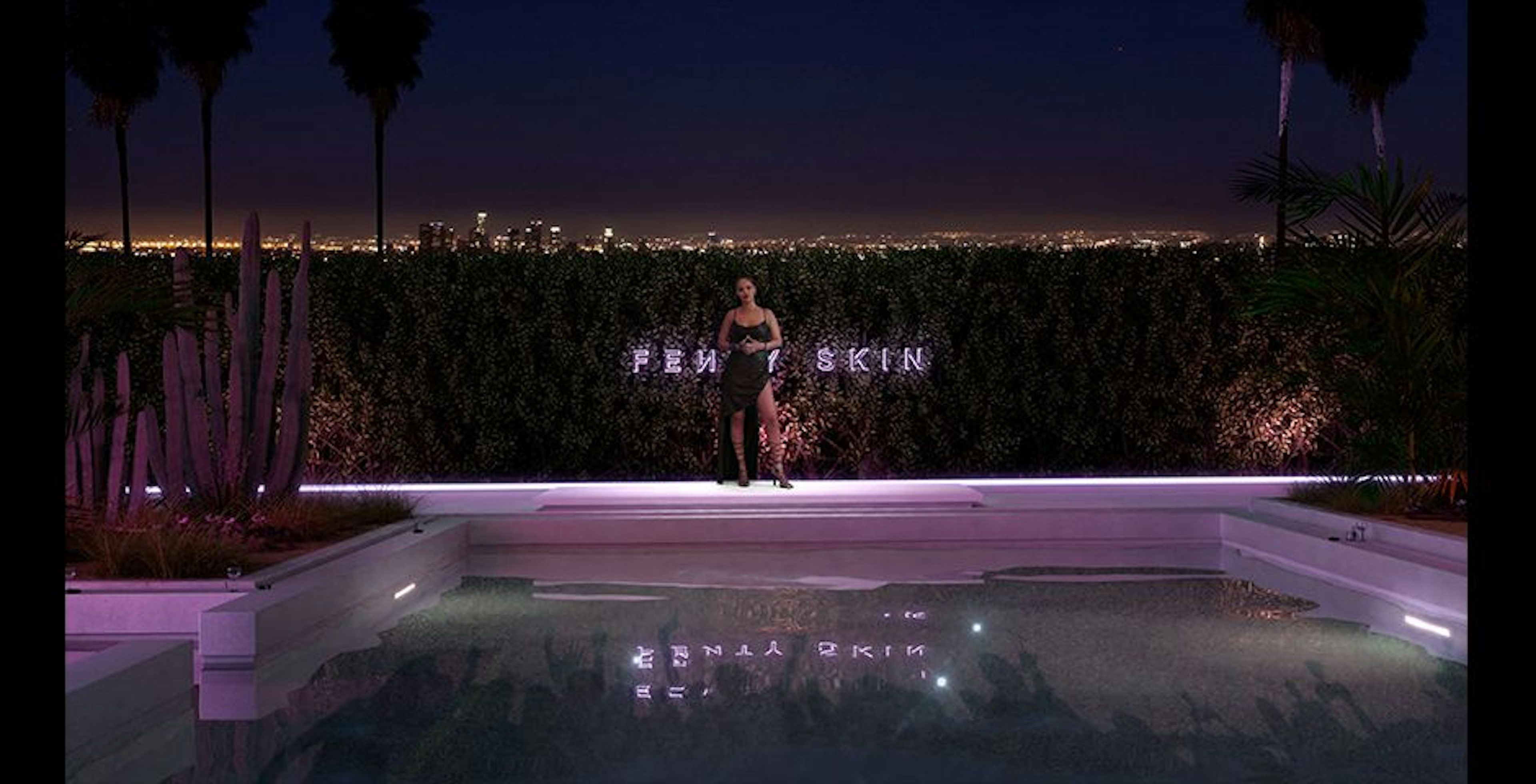 Image of Rihanna livestreaming standing beside the pool at the virtual house party